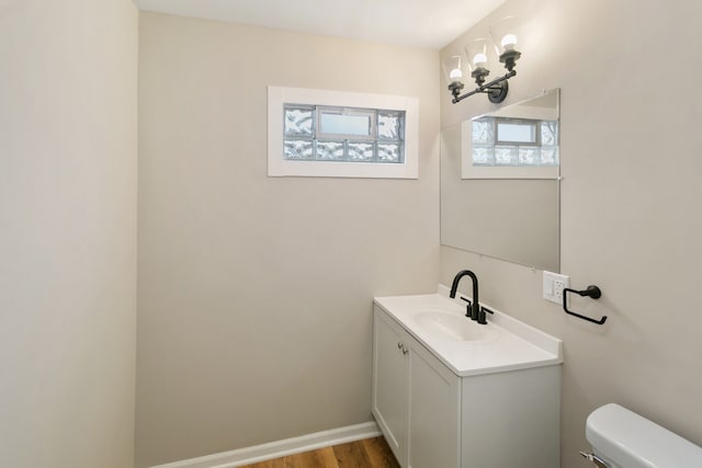 bathroom featuring hardwood / wood-style floors, vanity, and toilet