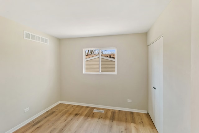 unfurnished room with light hardwood / wood-style floors