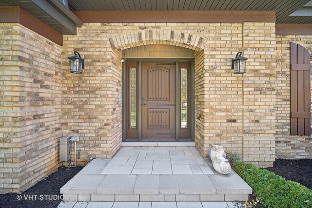 interior space with a stone fireplace, a chandelier, french doors, and a healthy amount of sunlight