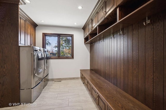 clothes washing area featuring separate washer and dryer