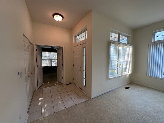 carpeted entryway featuring plenty of natural light