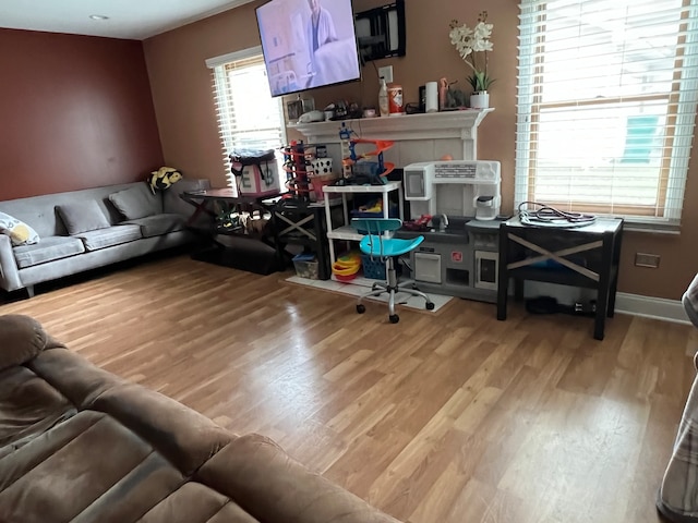 interior space with a fireplace and light hardwood / wood-style flooring