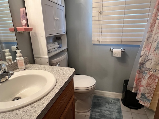 bathroom with vanity, toilet, and tile patterned floors