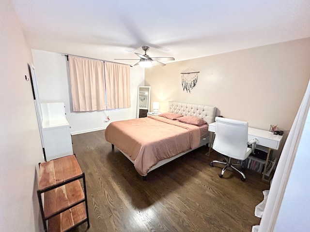 bedroom with dark hardwood / wood-style flooring and ceiling fan