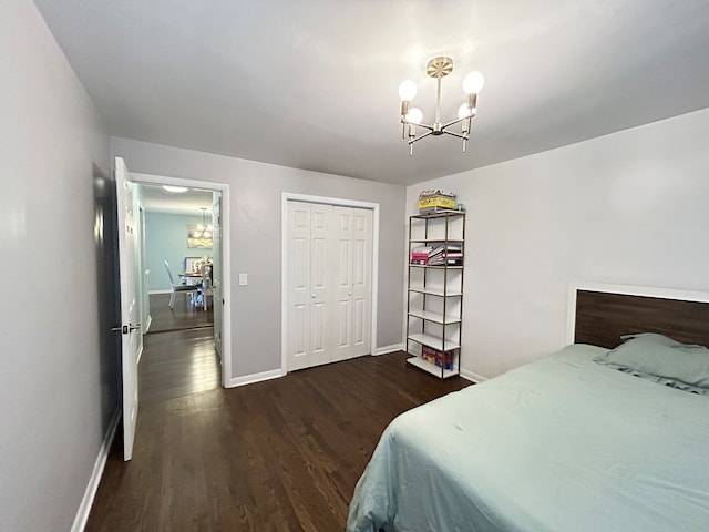 bedroom with a chandelier, a closet, and dark hardwood / wood-style floors