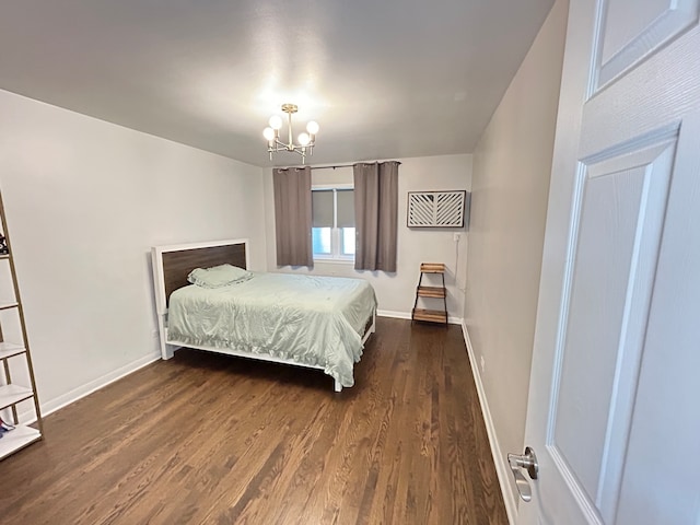 bedroom featuring a notable chandelier and dark hardwood / wood-style floors