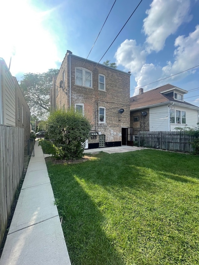 back of house with a lawn