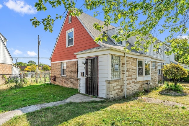 back of house with a lawn