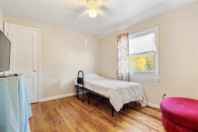 bedroom with light hardwood / wood-style floors and ceiling fan