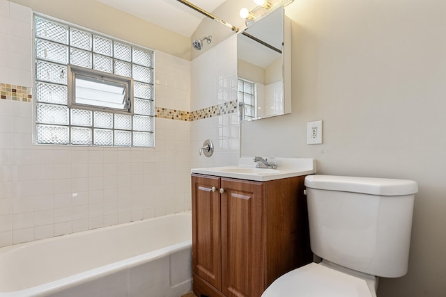 full bathroom featuring vanity, toilet, and tiled shower / bath