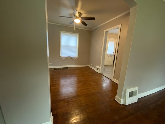 unfurnished room with ornamental molding, dark hardwood / wood-style floors, and ceiling fan