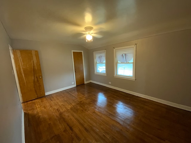 spare room featuring ceiling fan and dark wood-type flooring