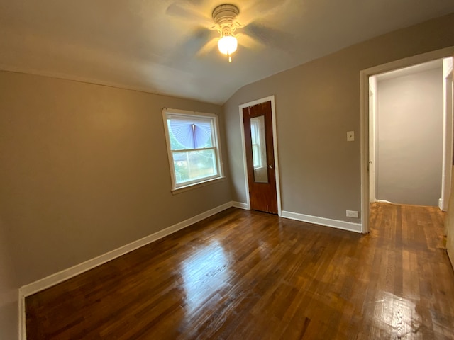 spare room with lofted ceiling, dark wood-type flooring, and ceiling fan