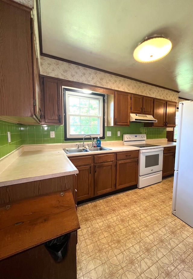 kitchen featuring white appliances and sink