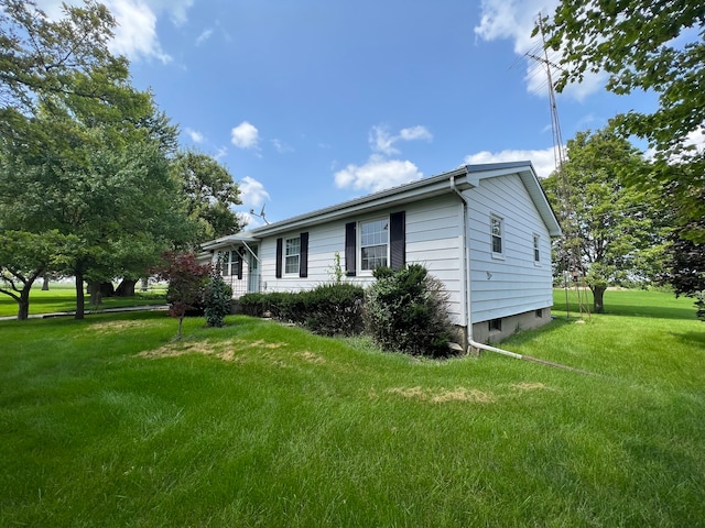 view of side of property with a lawn