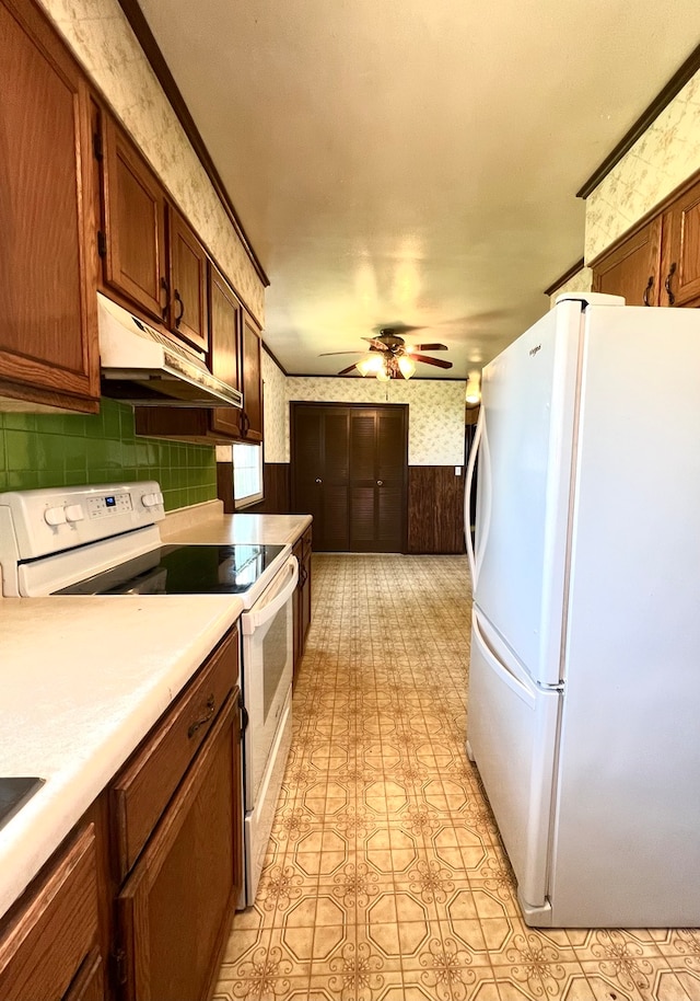 kitchen featuring ceiling fan, light tile patterned floors, ornamental molding, and white appliances