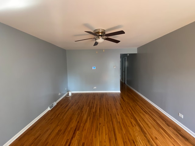 spare room featuring wood-type flooring and ceiling fan