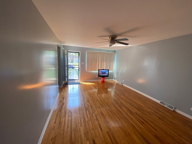 spare room with wood-type flooring and ceiling fan