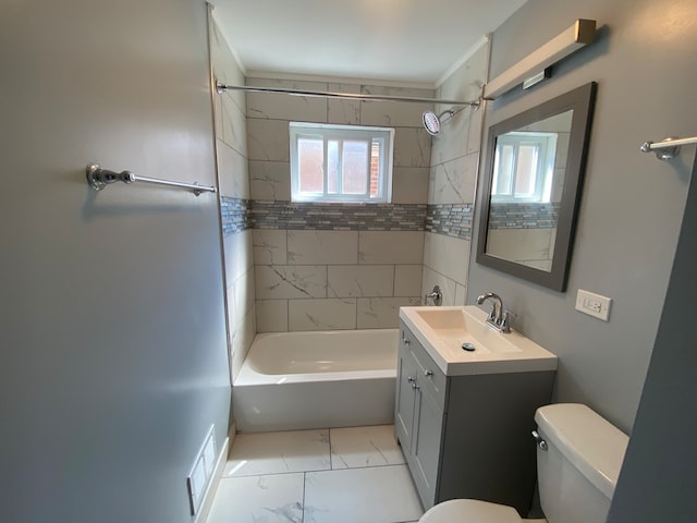 full bathroom featuring tiled shower / bath, vanity, crown molding, and toilet