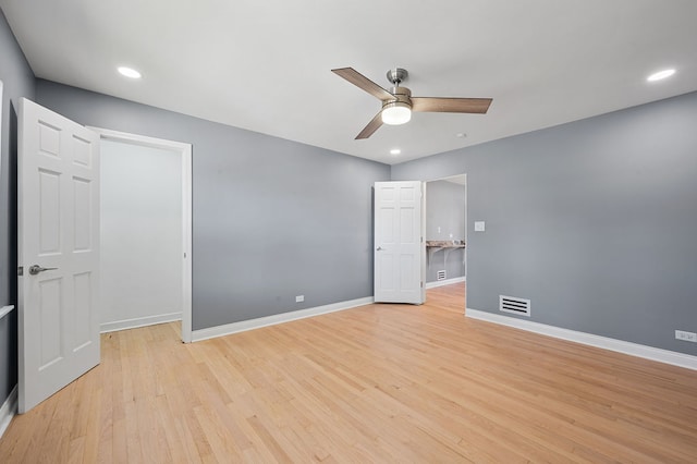 unfurnished bedroom featuring ceiling fan, a closet, and light hardwood / wood-style flooring