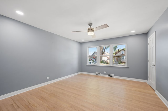 spare room featuring light wood-type flooring and ceiling fan