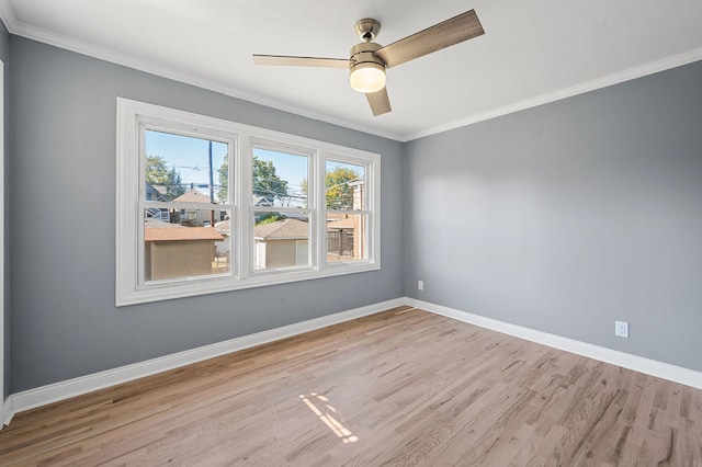 spare room with ornamental molding, light wood-type flooring, and ceiling fan