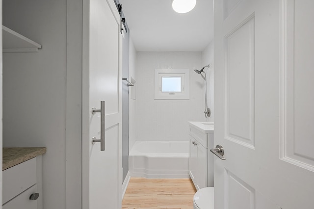 full bathroom with vanity, toilet, shower / bathing tub combination, and hardwood / wood-style flooring