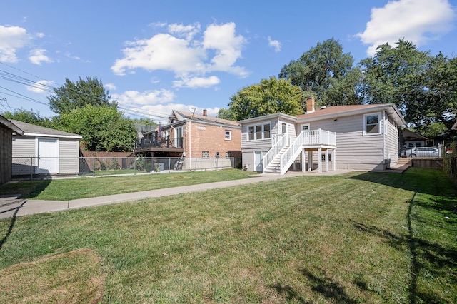 back of property with a yard and a deck