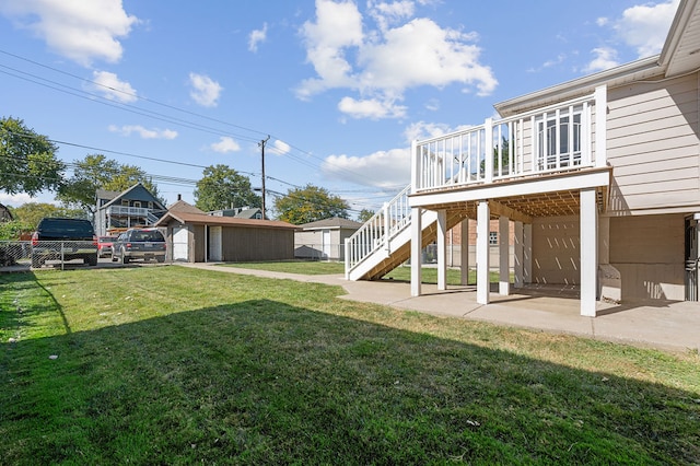 view of yard with a patio, a storage unit, and a wooden deck