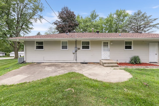 view of front of house with a front lawn and central AC unit