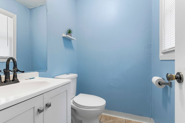 bathroom featuring tile patterned flooring, vanity, and toilet