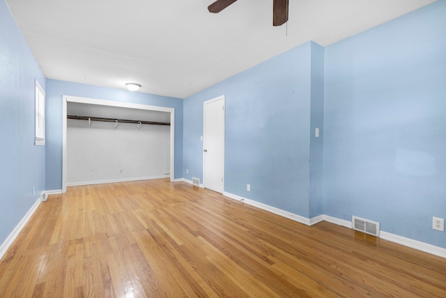 unfurnished bedroom with a closet, light hardwood / wood-style floors, and ceiling fan