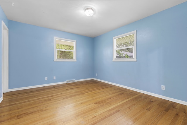 empty room with light hardwood / wood-style floors