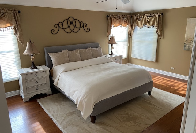 bedroom featuring hardwood / wood-style floors, vaulted ceiling, and ceiling fan