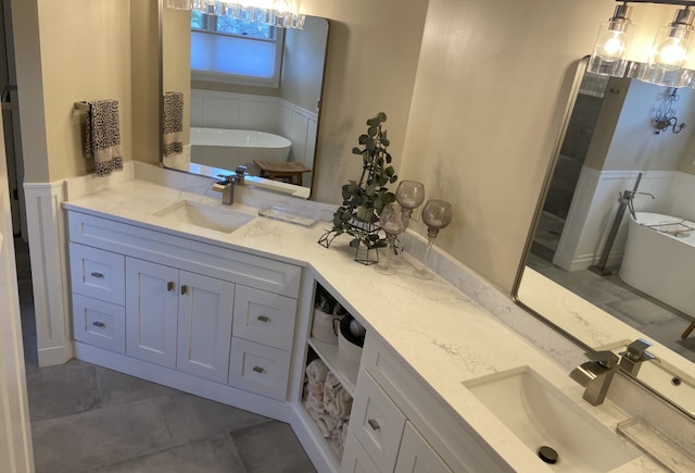 bathroom featuring a tub to relax in, tile patterned flooring, and vanity