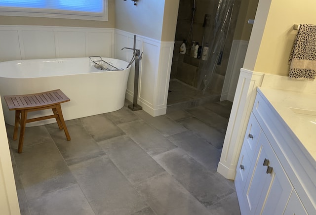 bathroom featuring vanity and independent shower and bath