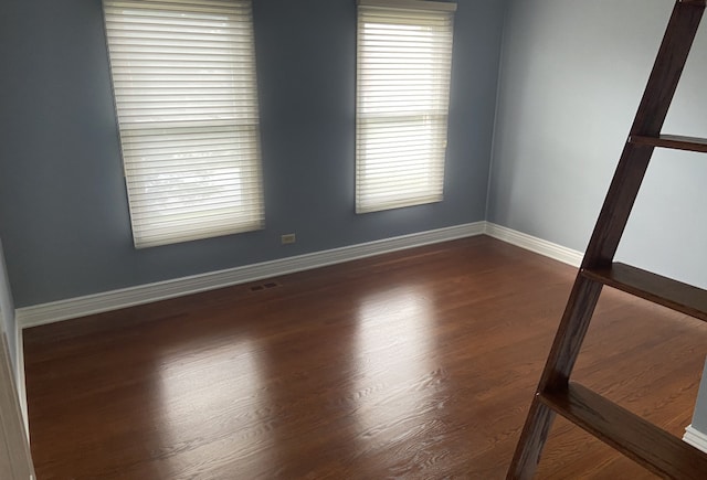 spare room with dark hardwood / wood-style floors