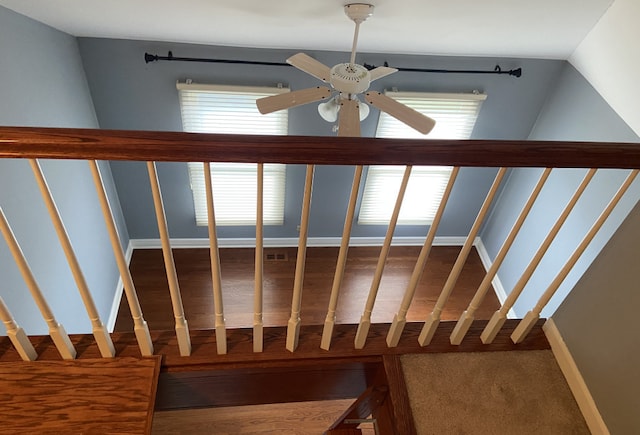 staircase featuring ceiling fan