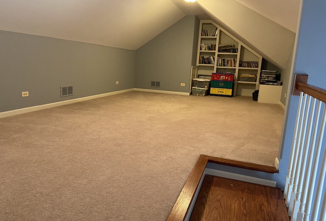 additional living space featuring carpet floors and lofted ceiling