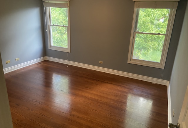 empty room featuring dark hardwood / wood-style flooring