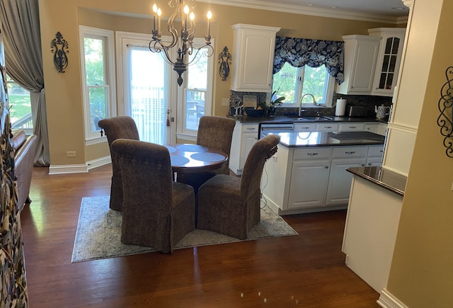 dining space featuring ornamental molding, dark hardwood / wood-style floors, and a healthy amount of sunlight