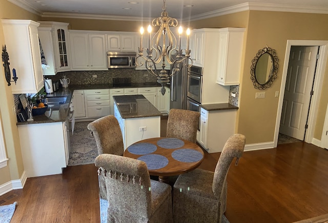 dining space featuring crown molding, dark hardwood / wood-style floors, and an inviting chandelier