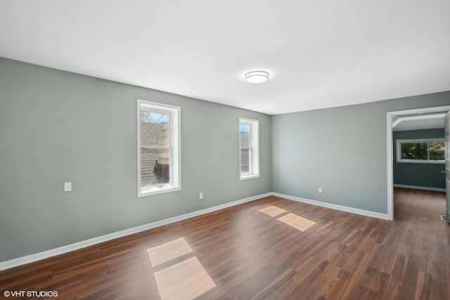 unfurnished room with dark hardwood / wood-style floors