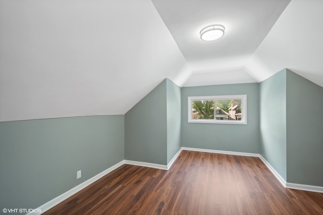 bonus room featuring lofted ceiling and dark wood-type flooring