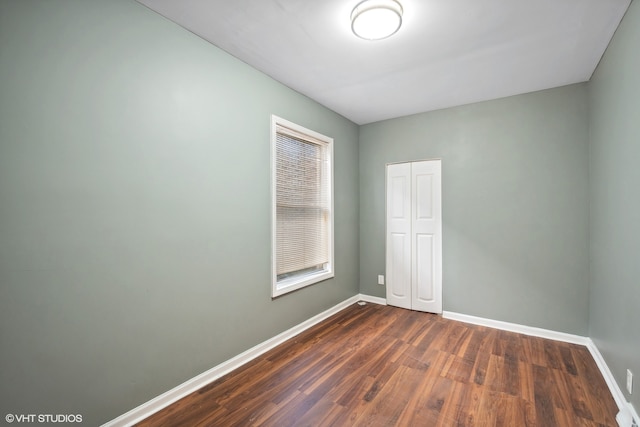 spare room featuring dark hardwood / wood-style floors