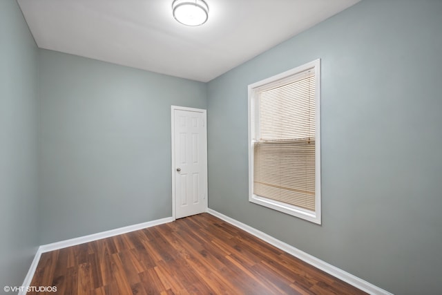 spare room featuring dark hardwood / wood-style floors