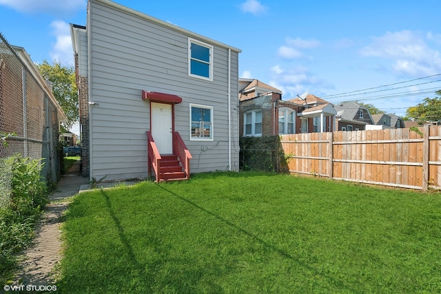 back of house featuring a yard