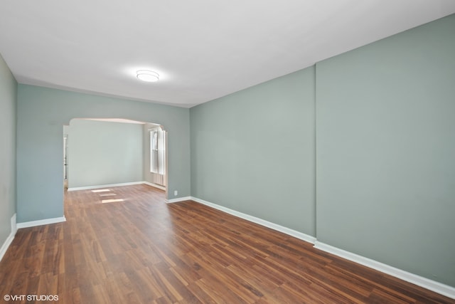 spare room featuring dark hardwood / wood-style flooring