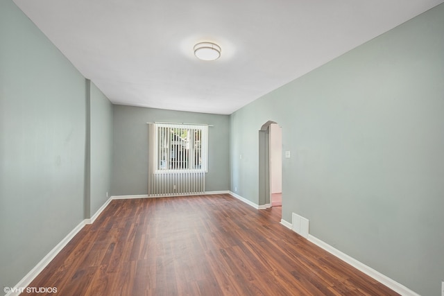 unfurnished room with dark hardwood / wood-style floors