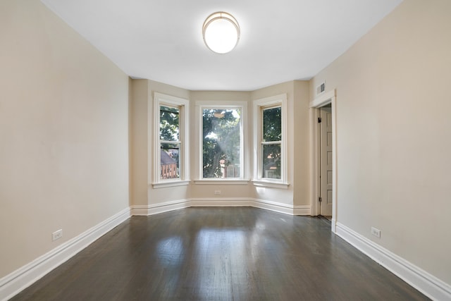 spare room featuring dark hardwood / wood-style flooring